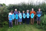 Group of people standing in a row holding up a sign that reads 2,000,000