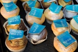 close-up of cup cakes with blue Mary's Meals logo on top