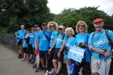 line of fundraisers in blue t-shirts out on a walk
