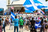 large crowd of people with Scotland flags in the air