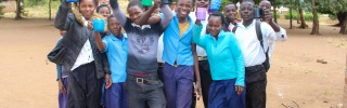 A group of children holding mugs up to the camera