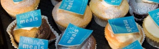 close-up of cup cakes with blue Mary's Meals logo on top