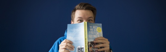 Man reading The Shed That Fed a Million Children book