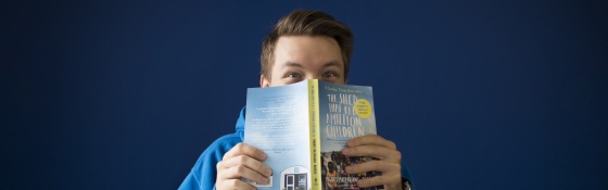 Man reading The Shed That Fed a Million Children book
