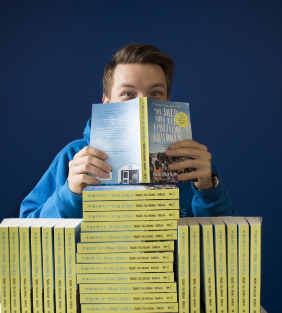 Man reading The Shed That Fed a Million Children book