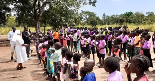 Sister giving an address to a group of assembled children